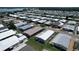 Expansive aerial view showcasing the neighborhood with neat rows of single-Gathering homes and proximity to a large lake at 6739 Kensington Ne Dr, Winter Haven, FL 33881