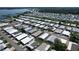 Overhead view of a mobile home community with a lake in the background, showcasing the community's layout at 6739 Kensington Ne Dr, Winter Haven, FL 33881