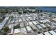 Expansive aerial view of a mobile home community near a lake, highlighting the neighborhood layout at 6739 Kensington Ne Dr, Winter Haven, FL 33881