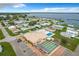 An aerial view features a community with pool, shuffleboard, and easy access to the lake at 6739 Kensington Ne Dr, Winter Haven, FL 33881