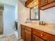 Well-lit bathroom features a glass enclosed shower, wood cabinets and neutral flooring at 6739 Kensington Ne Dr, Winter Haven, FL 33881