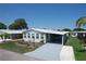 Charming single-story home with well-maintained lawn and paved driveway at 6739 Kensington Ne Dr, Winter Haven, FL 33881