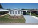 Charming single-story home with well-maintained landscaping, a carport, and neutral colors at 6739 Kensington Ne Dr, Winter Haven, FL 33881