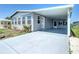 Charming single-story home with a covered carport and well-maintained landscaping, painted in neutral gray tones at 6739 Kensington Ne Dr, Winter Haven, FL 33881