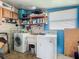 Functional laundry area features washer, dryer, sink, and cabinets for ample storage at 6739 Kensington Ne Dr, Winter Haven, FL 33881