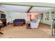 Spacious living room with traditional décor, a cozy seating area, and built-in shelves connecting to the dining space at 6739 Kensington Ne Dr, Winter Haven, FL 33881