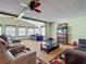 Comfortable living space featuring classic décor, a fireplace, and smooth transition to a sunlit sitting area, ideal for relaxing at 6739 Kensington Ne Dr, Winter Haven, FL 33881