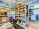 Storage room with bright blue walls, peg board and ceiling fan at 6739 Kensington Ne Dr, Winter Haven, FL 33881