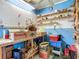 Storage room with bright blue walls, peg board and ceiling fan at 6739 Kensington Ne Dr, Winter Haven, FL 33881