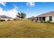 Large backyard with grassy area and distant home views at 1518 Blue Sky Blvd, Haines City, FL 33844