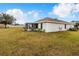 Home's exterior showcasing a large backyard and screened patio at 1518 Blue Sky Blvd, Haines City, FL 33844