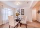 Dining room with glass table, four chairs, and wall art at 1518 Blue Sky Blvd, Haines City, FL 33844