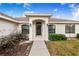 House entrance with a covered porch and walkway, showing a well-maintained exterior at 1518 Blue Sky Blvd, Haines City, FL 33844