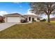 Single-story house with attached garage, and a well-maintained lawn at 1518 Blue Sky Blvd, Haines City, FL 33844