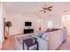 Living room with sectional sofa and ceiling fan at 1518 Blue Sky Blvd, Haines City, FL 33844