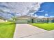 Two-story house with green exterior, landscaping, and a two-car garage at 4024 Tullamore Ln, Auburndale, FL 33823