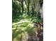 Expansive backyard with mature shade trees and lush green grass at 4450 Old Berkley Rd, Auburndale, FL 33823