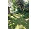 Private backyard area with a well-maintained lawn and mature trees at 4450 Old Berkley Rd, Auburndale, FL 33823