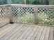Inviting wood deck with decorative string lights and a view of the surrounding greenery at 4450 Old Berkley Rd, Auburndale, FL 33823