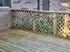Wood deck features string lights and lattice railing, perfect for outdoor enjoyment at 4450 Old Berkley Rd, Auburndale, FL 33823