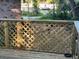 Close-up of a wooden deck with string lights wrapped around the railing, creating a cozy ambiance at 4450 Old Berkley Rd, Auburndale, FL 33823