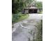 Shows the property's cracked cement driveway to the two car garage at 4450 Old Berkley Rd, Auburndale, FL 33823