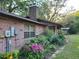 Shows the brick exterior elevation with well maintained landscape and plants at 4450 Old Berkley Rd, Auburndale, FL 33823