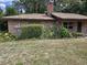 Exterior view of the house with brick facade and manicured landscaping at 4450 Old Berkley Rd, Auburndale, FL 33823