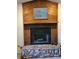 The fireplace is constructed from stone and has wood finish above at 4450 Old Berkley Rd, Auburndale, FL 33823