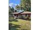 A cozy brick home with a chimney and lush green lawn at 4450 Old Berkley Rd, Auburndale, FL 33823