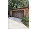 Attached garage with brick siding and concrete driveway at 4450 Old Berkley Rd, Auburndale, FL 33823