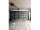 Spacious garage with a multi-panel door ready for vehicles at 4450 Old Berkley Rd, Auburndale, FL 33823