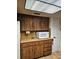 Functional kitchen with wood cabinets and updated appliances at 4450 Old Berkley Rd, Auburndale, FL 33823