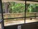 Tranquil screened porch surrounded by lush greenery at 4450 Old Berkley Rd, Auburndale, FL 33823