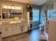 Bathroom with a double sink vanity, modern lighting, and a glass enclosed shower at 416 Sandestin Dr, Winter Haven, FL 33884