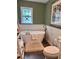 Elegant bathroom featuring a standalone tub, wainscoting, and a unique stained glass window at 416 Sandestin Dr, Winter Haven, FL 33884