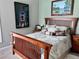 Comfortable bedroom featuring stylish wood furniture and a decorative leaf-patterned comforter set at 416 Sandestin Dr, Winter Haven, FL 33884