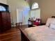 Bedroom with a bed, dresser, hardwood floors, and French doors with access to the outside at 416 Sandestin Dr, Winter Haven, FL 33884