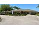 Community clubhouse featuring attractive landscaping and a well-maintained parking area at 416 Sandestin Dr, Winter Haven, FL 33884