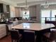Bright kitchen featuring white cabinets, a large island with bar seating, and a modern range hood at 416 Sandestin Dr, Winter Haven, FL 33884