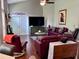 Living room features a brick fireplace, high ceilings, a ceiling fan, and comfortable seating at 416 Sandestin Dr, Winter Haven, FL 33884