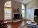 Beautiful fireplace with stone surround, windows, and access to the outside at 416 Sandestin Dr, Winter Haven, FL 33884