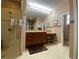Large bathroom with double sinks, tile flooring, and clear glass shower at 4577 Back Nine Dr, Winter Haven, FL 33884