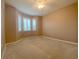 Carpeted bedroom with three windows with shutters and a ceiling fan at 4577 Back Nine Dr, Winter Haven, FL 33884