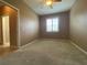 This carpeted bedroom features a bright window with shutters and a ceiling fan at 4577 Back Nine Dr, Winter Haven, FL 33884