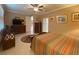 Nicely decorated bedroom featuring neutral walls, striped bedding, and decorative furniture at 4577 Back Nine Dr, Winter Haven, FL 33884