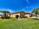 Beautiful single-story home surrounded by well-kept landscaping and green grass at 4577 Back Nine Dr, Winter Haven, FL 33884