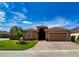 Charming single-Gathering home showcasing beautiful landscaping and a paver driveway at 4577 Back Nine Dr, Winter Haven, FL 33884