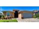 Inviting single-story home with lush landscaping and a brick driveway at 4577 Back Nine Dr, Winter Haven, FL 33884