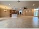Open-concept living area with tile floors, ceiling fans, and a view of the modern kitchen at 4577 Back Nine Dr, Winter Haven, FL 33884